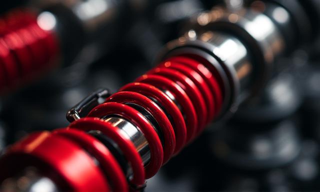 Close up of a high-performance red coilover suspension system